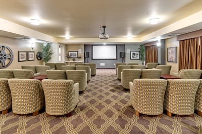 Interior view of a common area with seating and a screen