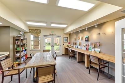 Bright activity room with art displayed on tables