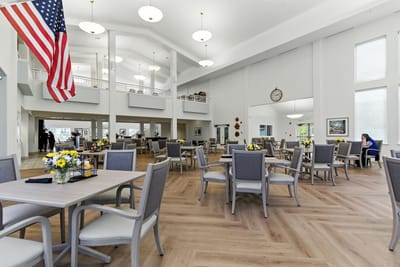 Bright dining room with flowers and residents enjoying the space