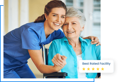 A caregiver smiling with a senior resident in a bright room