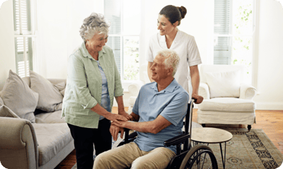 Care staff assisting residents in a bright living area