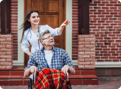 A caregiver assisting a resident outdoors
