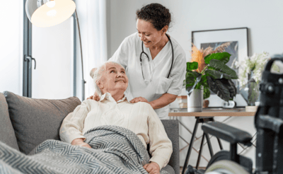 Caregiver smiling with a resident in a cozy living area