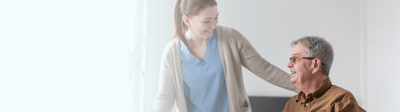 Staff assisting a resident in a cozy interior