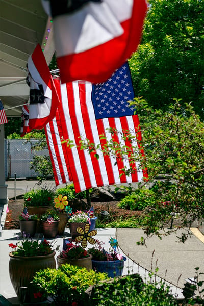 Patio area with American flags and flower pots