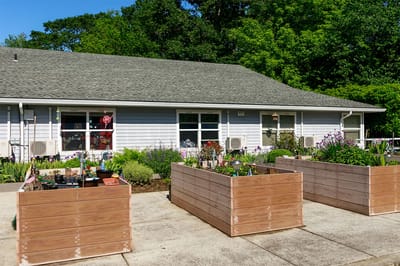 Garden area with raised planting beds in front of the facility