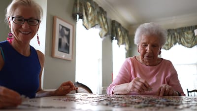 Residents enjoying a jigsaw puzzle together