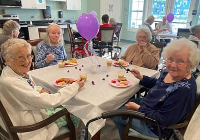 Residents enjoying a meal together at a dining table