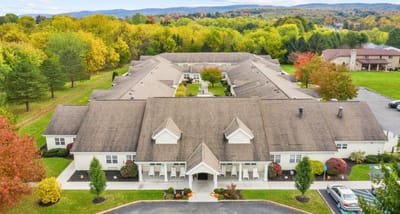 Aerial view of a senior living facility surrounded by trees