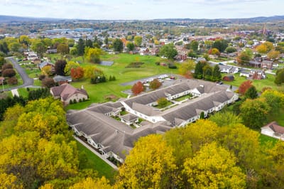 Aerial view of Barnes Place surrounded by autumn foliage