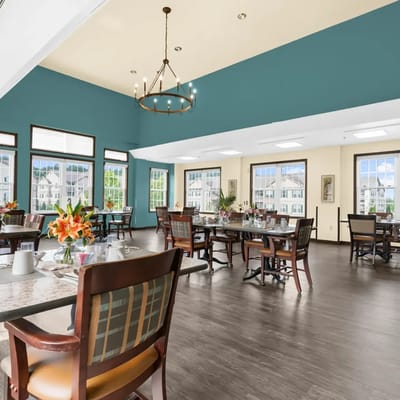 Bright dining room with tables and flowers