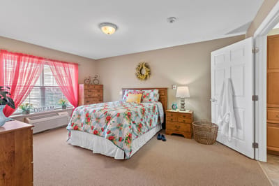 Cozy resident room with floral bedding and natural light