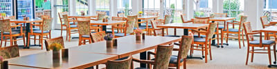 Dining room setup with tables and chairs.