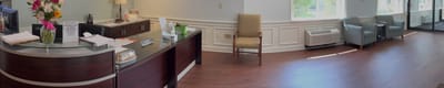 Bright reception area with seating and flowers