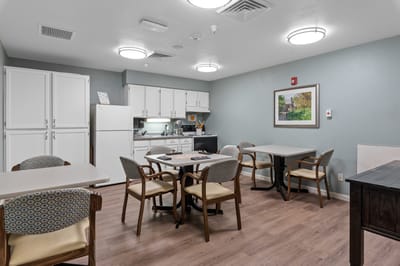 Bright common area with tables and kitchenette