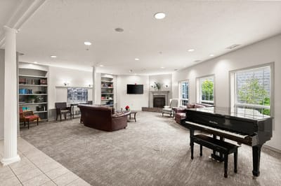 Bright common area with piano and seating