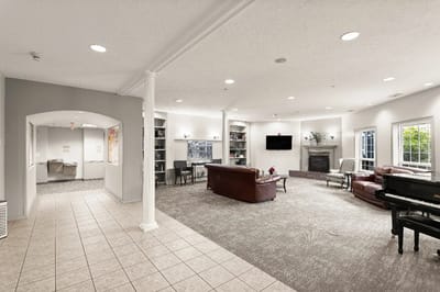 Bright common area with seating and piano