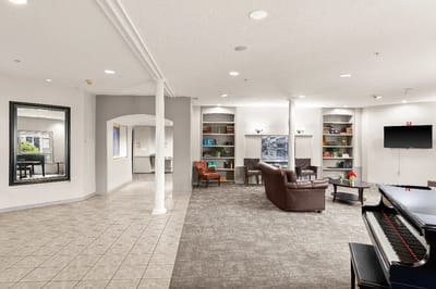 Interior of a common area with seating and a piano