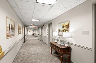 A hallway in a senior living facility with decorative lamps