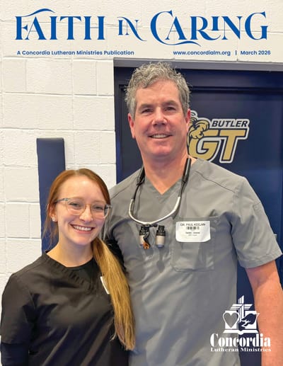 A healthcare professional posing with a staff member