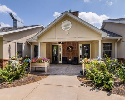 Building entrance with outdoor seating and flowers