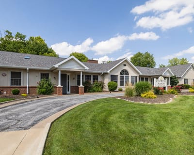 Exterior view of Country Manor facility with manicured lawn
