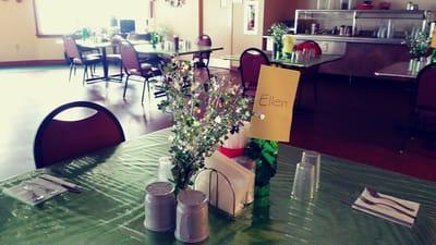 Dining room setup with place settings and decorations