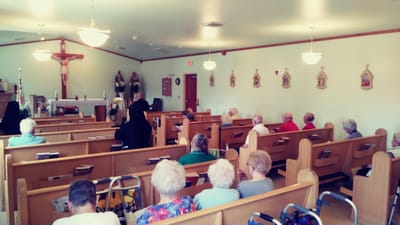 Residents attending a service in a chapel setting
