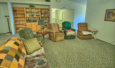 Cozy common area with comfortable chairs and bookshelves