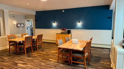 A common area with tables and chairs in a bright room