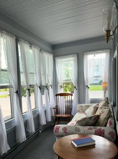 Bright sunroom with comfortable seating and natural light