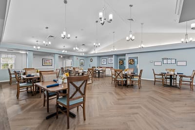 Bright dining room with tables set for meals