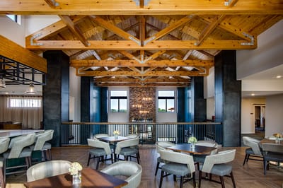 Bright common area featuring wooden beams and seating