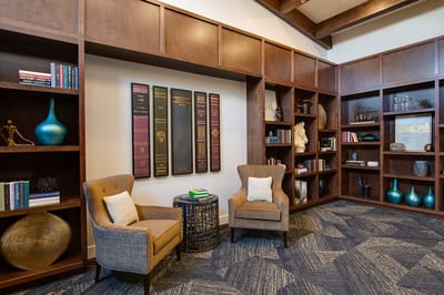 Cozy reading nook in a common area with bookshelves