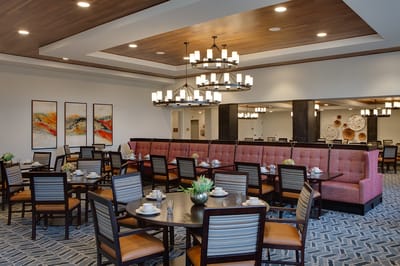 Dining area with tables and chandelier lighting