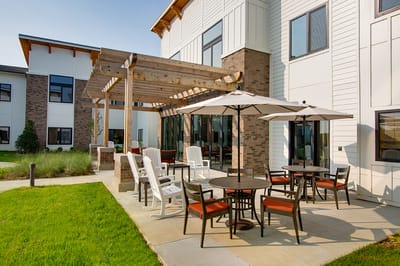 Outdoor patio area with seating at a senior living facility