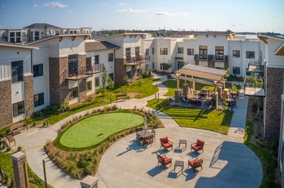 Outdoor courtyard with seating areas and green space