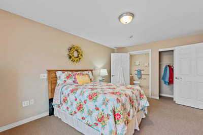 Brightly decorated private resident room with a bed and closet