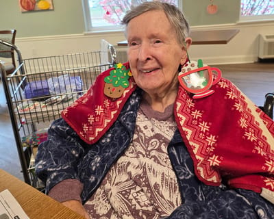 A resident wearing festive accessories during an activity