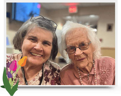 Two residents smiling together in a common area