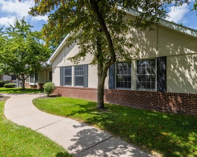 Exterior view of a senior living facility with green spaces