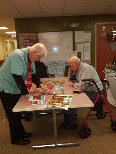 Residents engaging in a puzzle activity in a common area