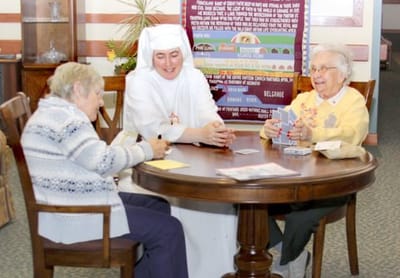 Residents engaging in an activity with staff member