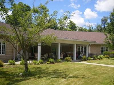 Exterior view of John Paul II Manor with outdoor seating