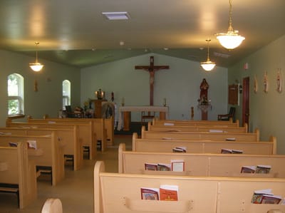 Interior view of a chapel with pews and altar
