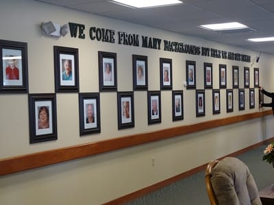 Gallery wall showcasing residents' photographs in a common area