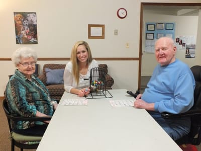 Residents and staff enjoying a bingo game in a common area