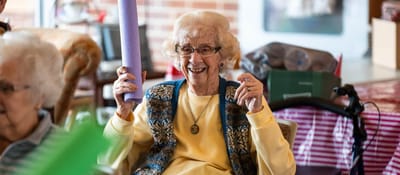 Residents enjoying activities in a lively common area