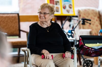Resident participating in an exercise activity indoors