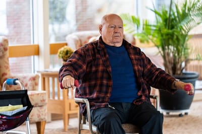 Resident exercising with weights in activity space